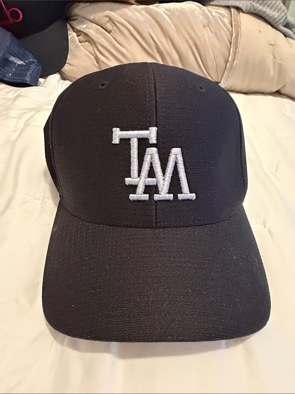 Travis Mathew Black Cap with Gold Embroidered Accent
